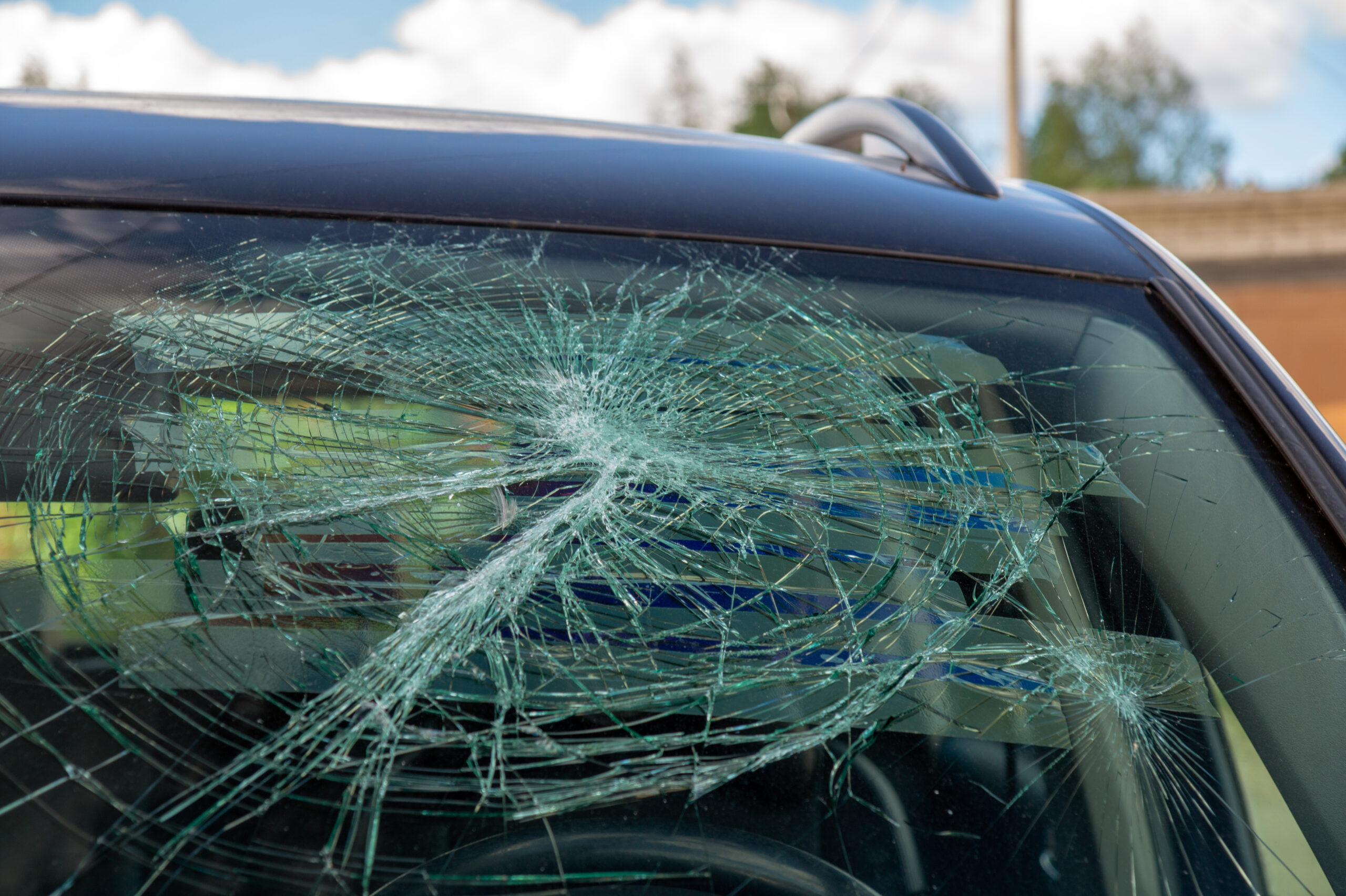 A broken car windshield after a hit and run accident.