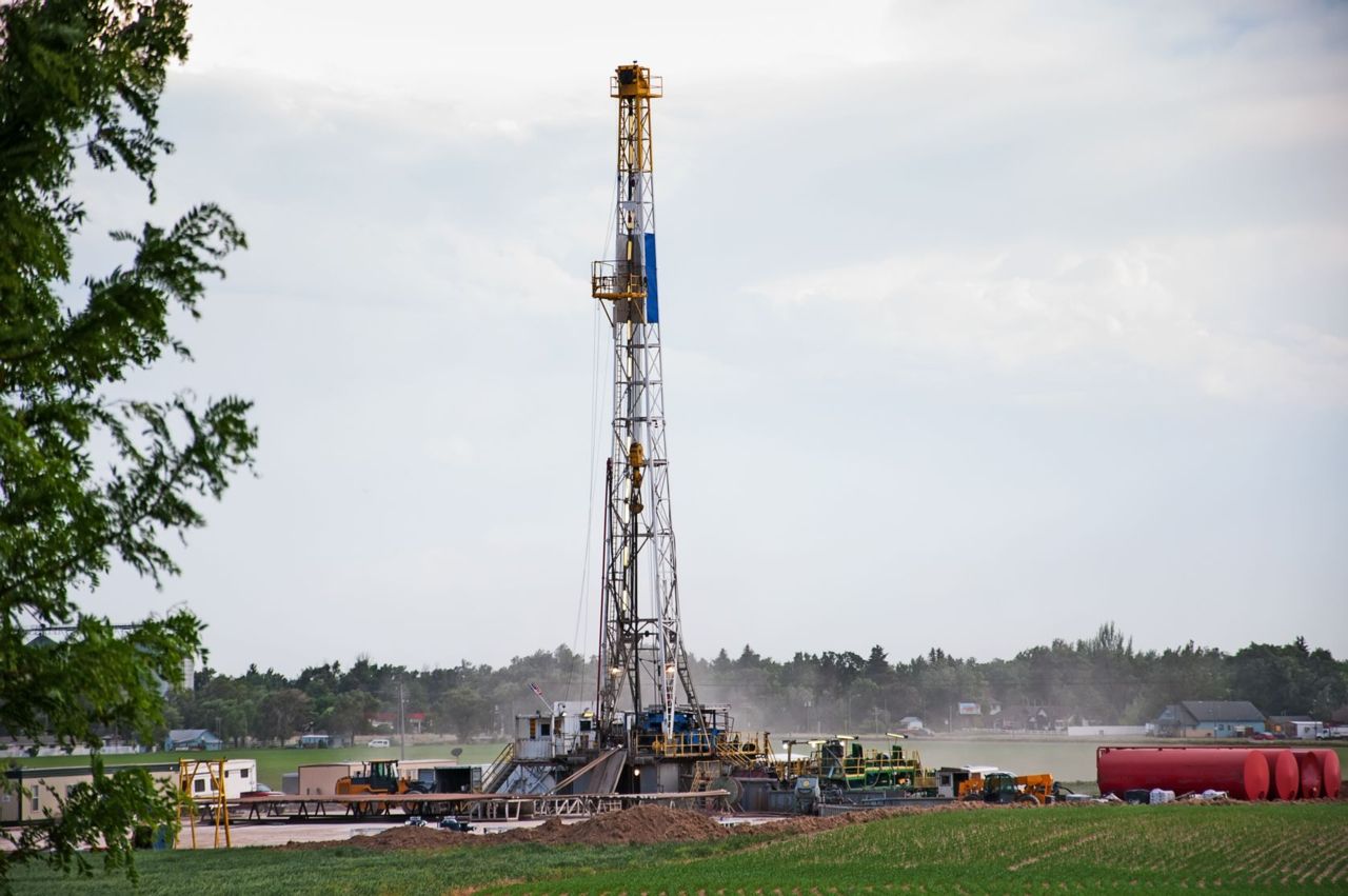 A natural gas drilling rig in a field.