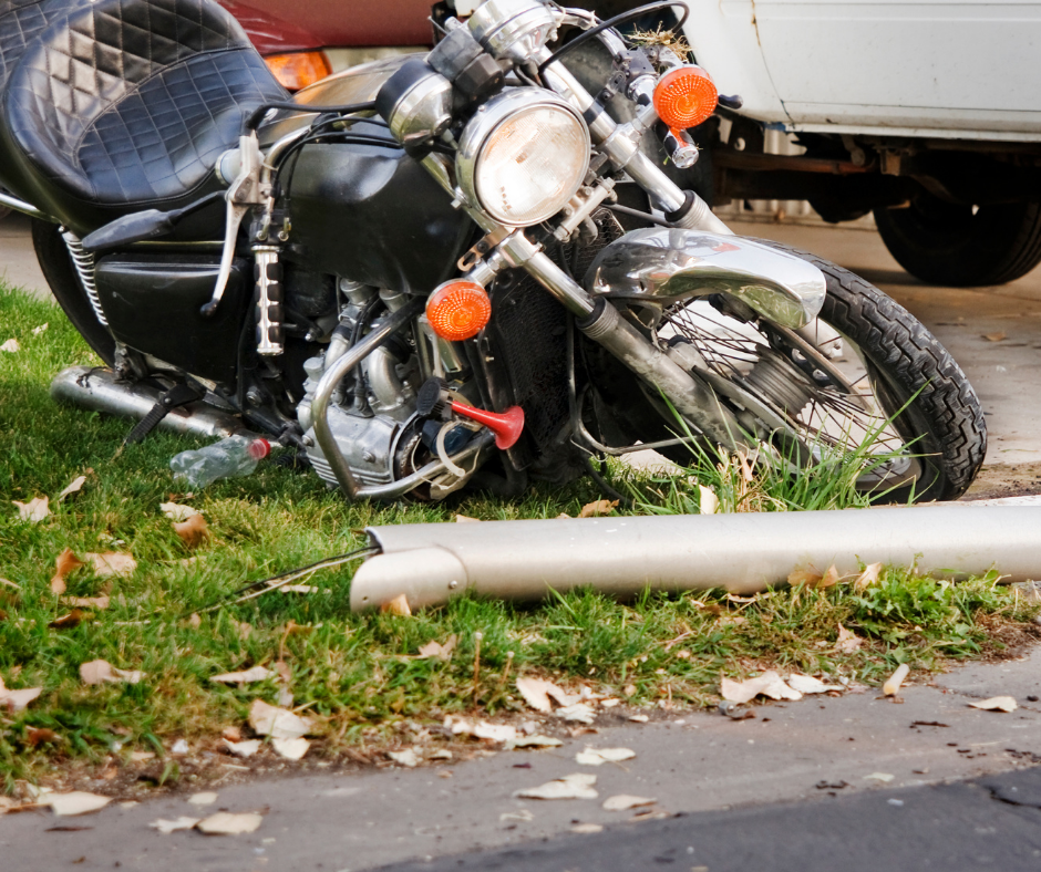 Damaged motorcycle on the grass after being crashed